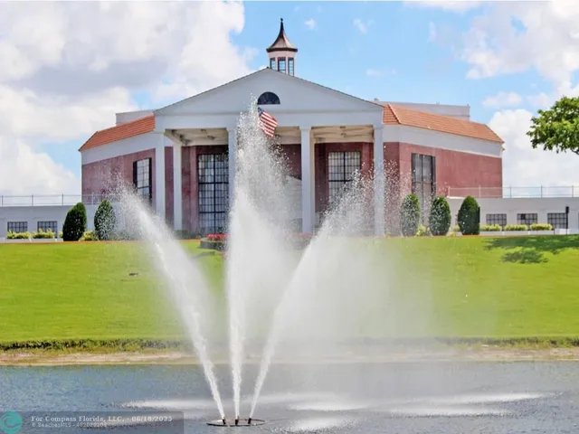 an aerial view of a house with a garden and lake view