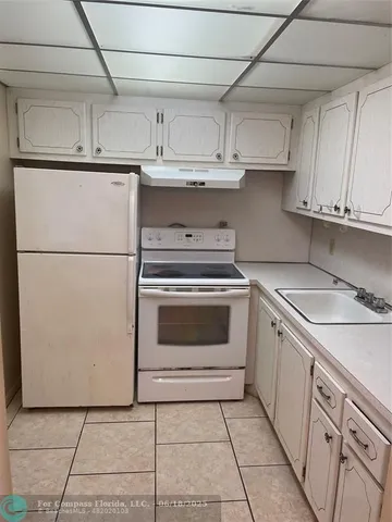 a kitchen with cabinets and white appliances