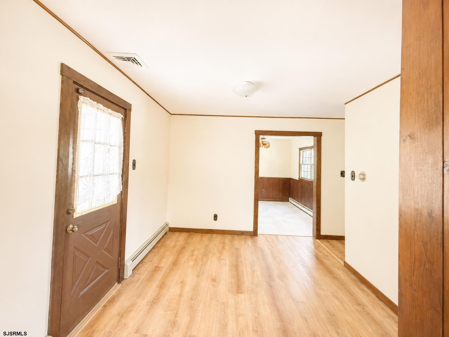 40 Old New York Road Galloway Township, NJ 08205 - Photo 3 of 18 a view of an empty room with wooden floor and a window