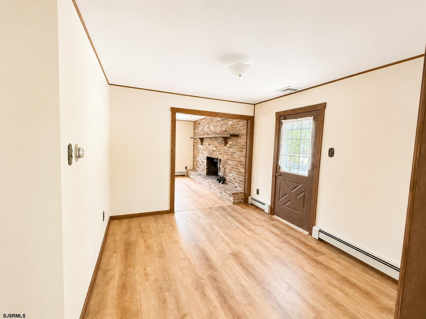 40 Old New York Road Galloway Township, NJ 08205 - Photo 6 of 18 a view of a hallway with wooden floor and a bathroom