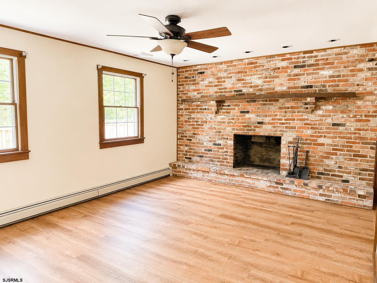 40 Old New York Road Galloway Township, NJ 08205 - Photo 7 of 18 a view of an empty room with wooden floor and a fireplace
