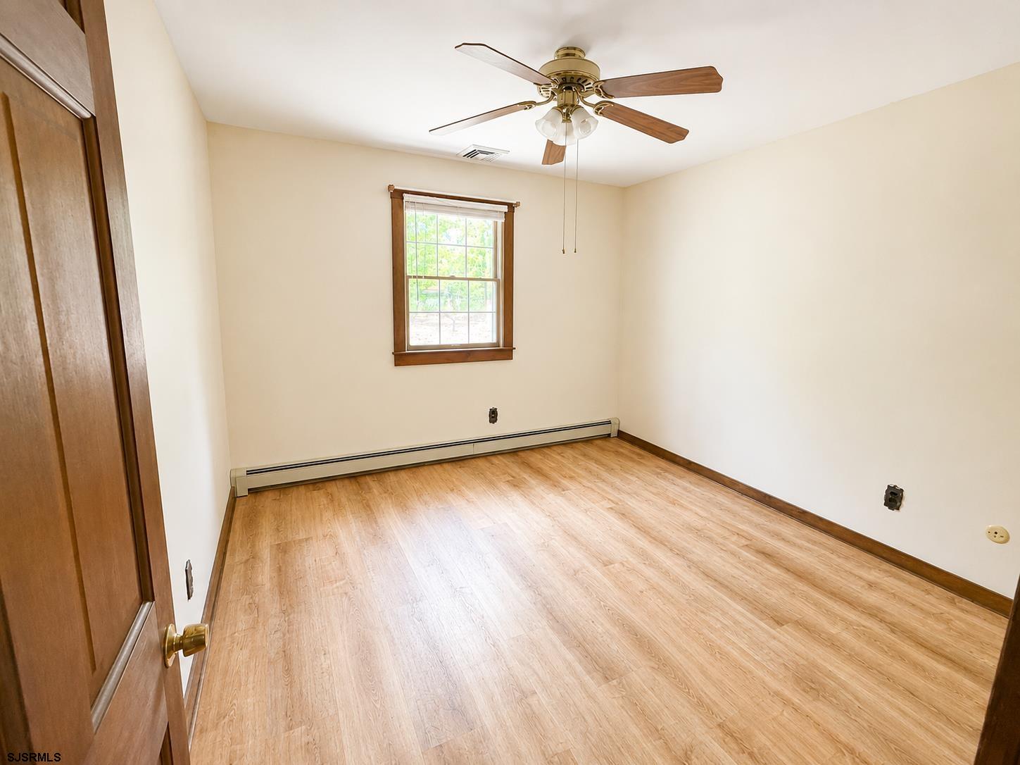 40 Old New York Road Galloway Township, NJ 08205 - Photo 10 of 18 wooden floor in an empty room with a window