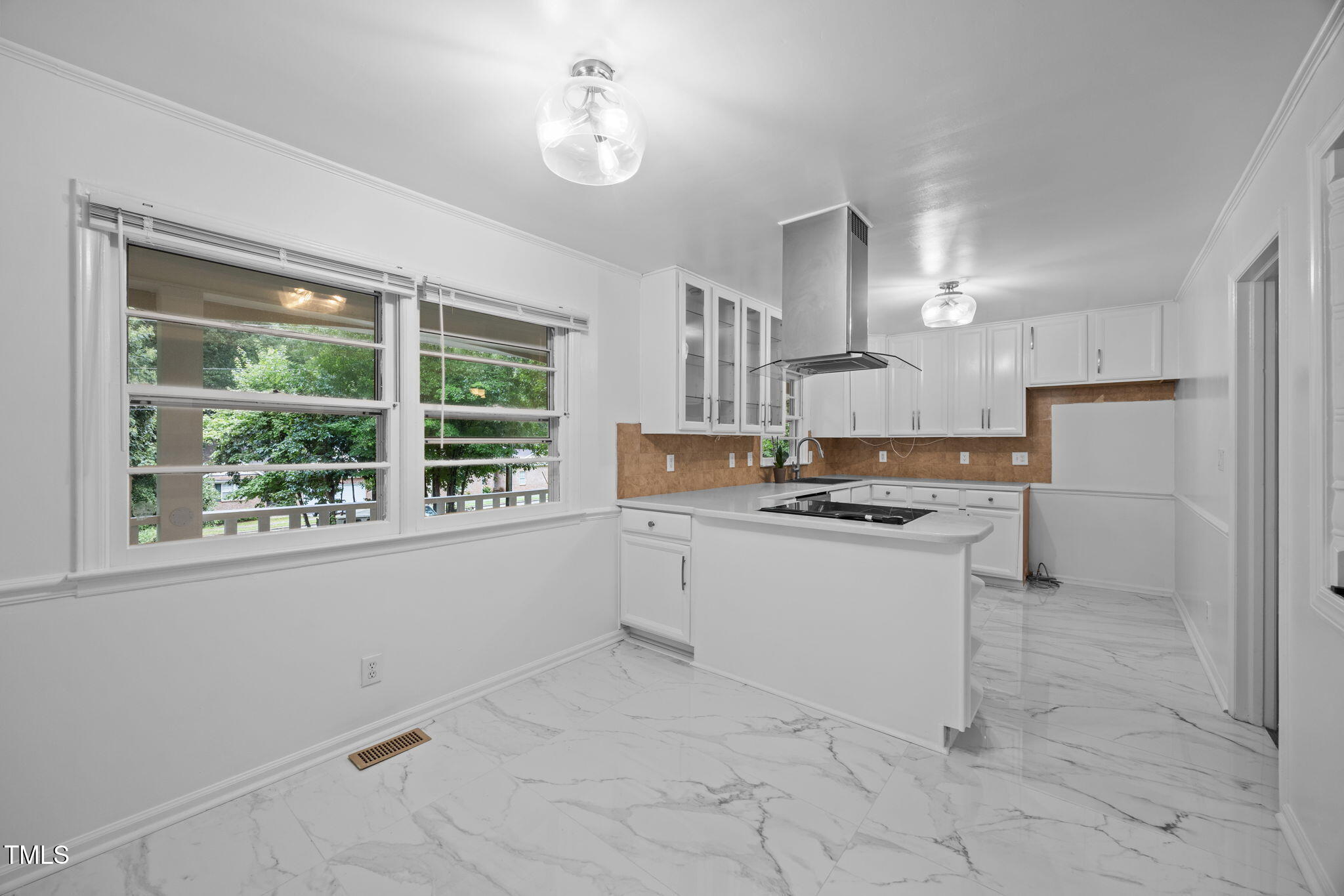 a kitchen with a stove a sink and a refrigerator