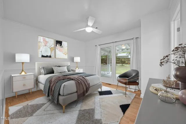 a bedroom with furniture and a large window