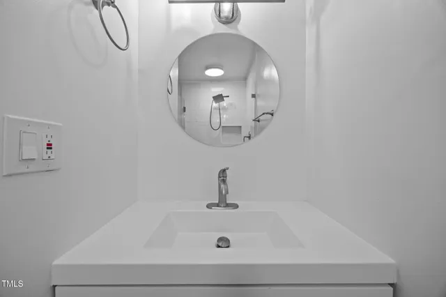 a bathroom with a sink and mirror