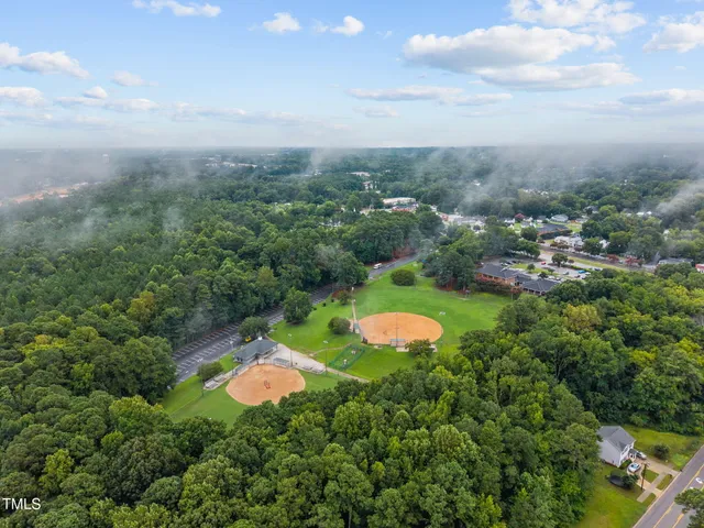 an aerial view of a house with a yard and lake view
