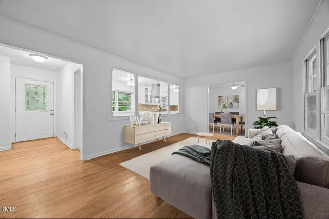 a large bedroom with a bed and wooden floor