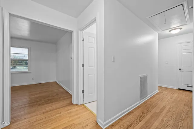 a view of a room with wooden floor