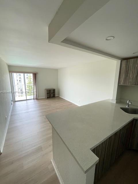 4550 Northwest 9th Street, Unit 803E Miami, FL 33126 - Photo 13 of 31 a view of kitchen and empty room with wooden floor