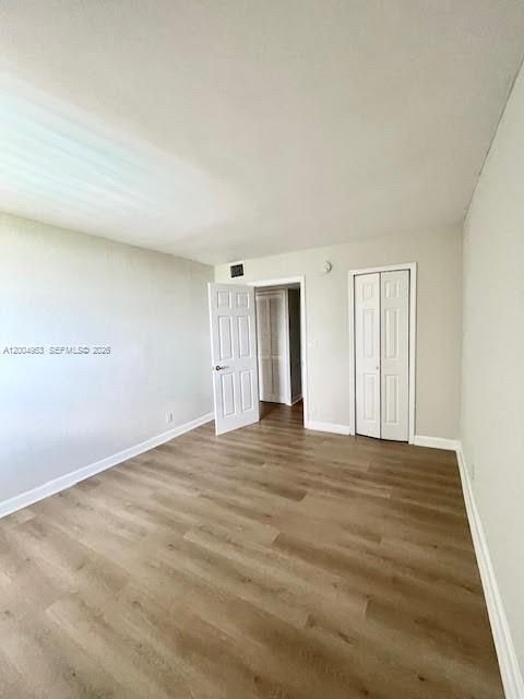 4550 Northwest 9th Street, Unit 803E Miami, FL 33126 - Photo 15 of 31 a view of an empty room with wooden floor