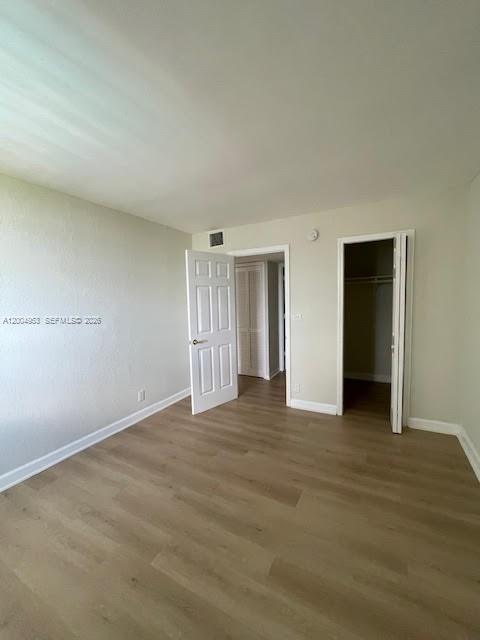 4550 Northwest 9th Street, Unit 803E Miami, FL 33126 - Photo 16 of 31 a view of an empty room with wooden floor