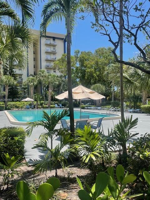 4550 Northwest 9th Street, Unit 803E Miami, FL 33126 - Photo 4 of 31 a backyard of a house with lots of green space and fountain