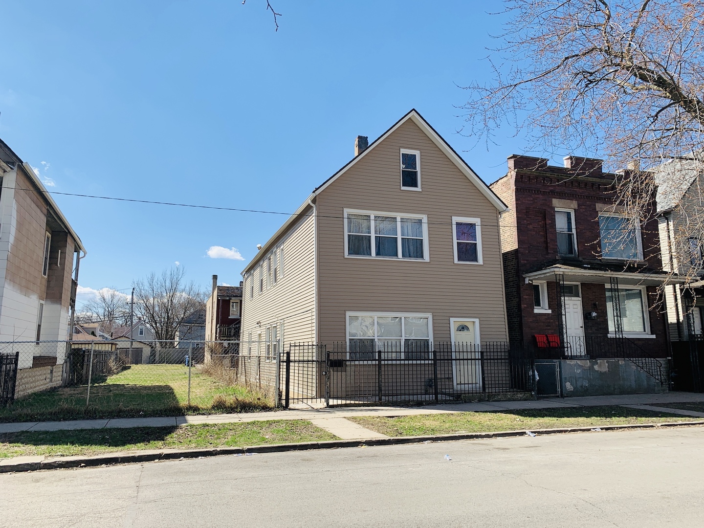 317 East 116th Street Chicago, IL 60628 - Photo 16 of 17 a front view of a house with a garden