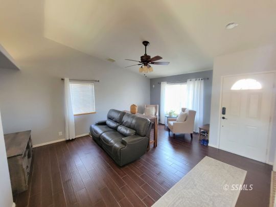 1113 West Iowa Avenue Ridgecrest, CA 93555 - Photo 5 of 21 a living room with furniture and a wooden floor