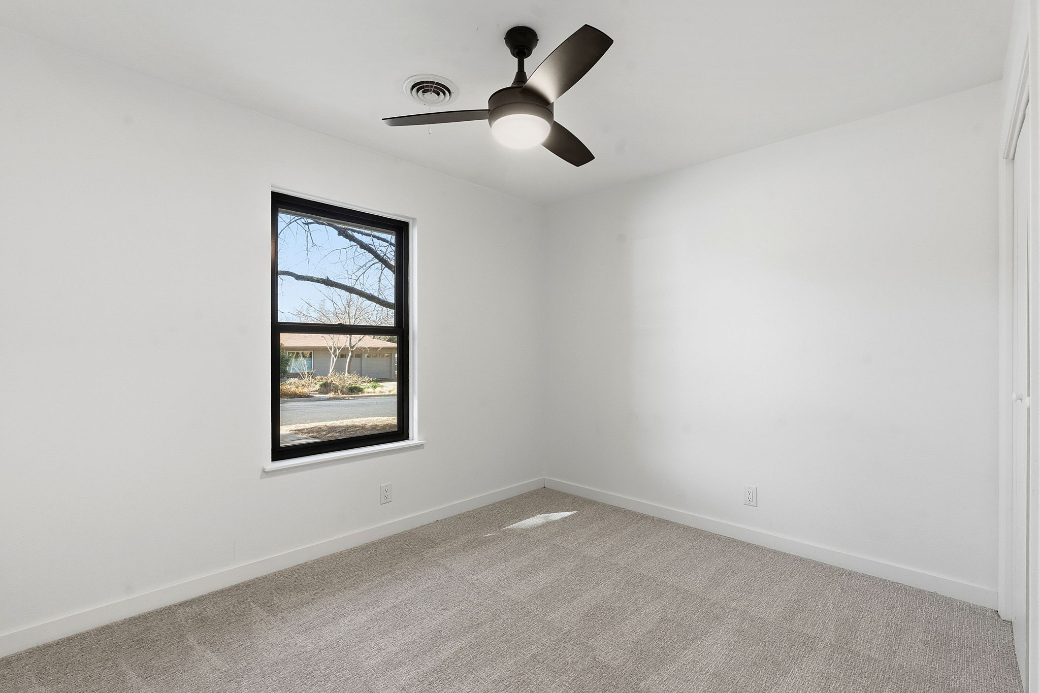 5609 Mapleleaf Drive Austin, TX 78723 - Photo 14 of 19 Carpeted empty room featuring baseboards and ceiling fan