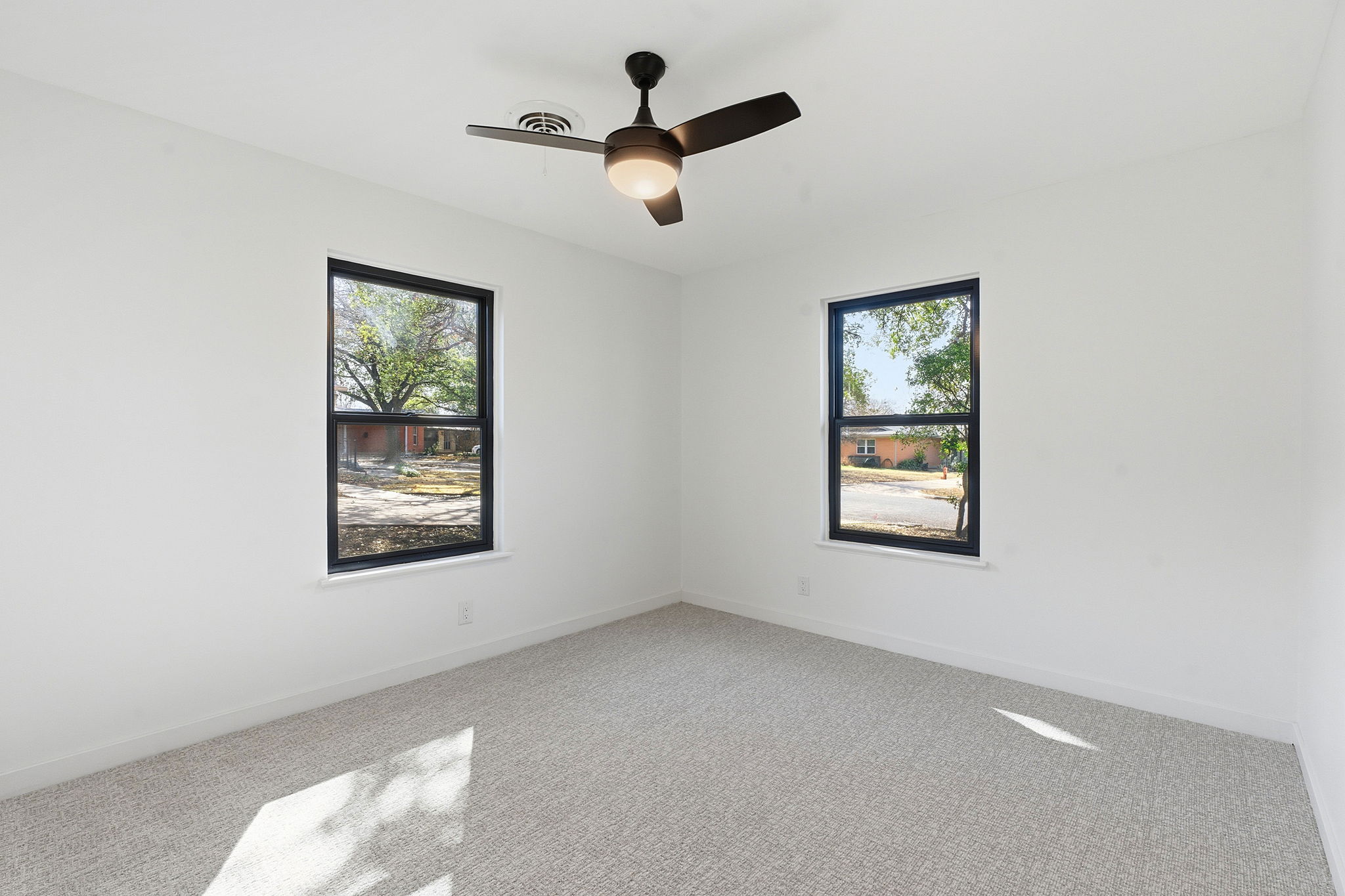5609 Mapleleaf Drive Austin, TX 78723 - Photo 15 of 19 Carpeted spare room featuring baseboards and ceiling fan