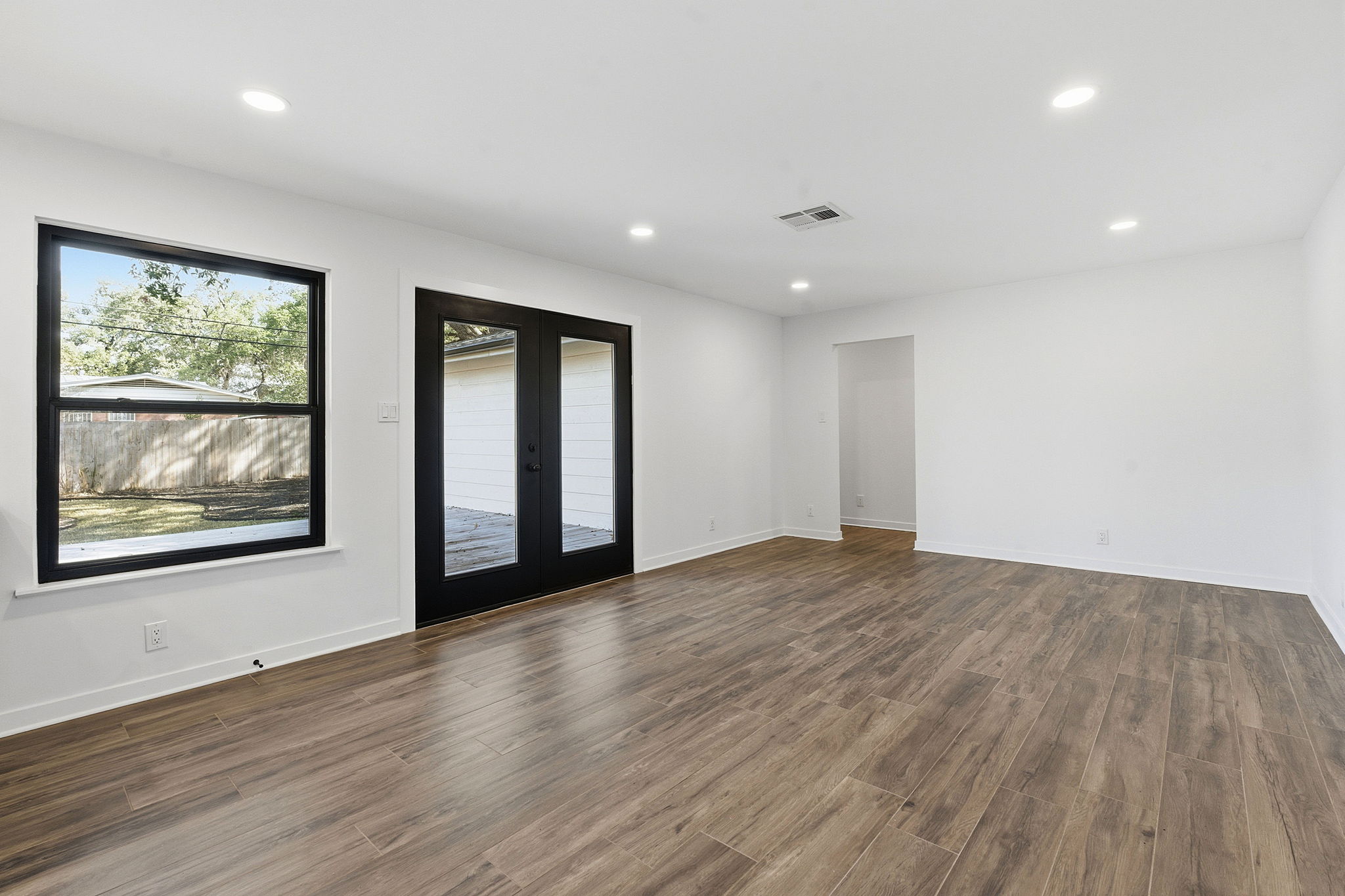 5609 Mapleleaf Drive Austin, TX 78723 - Photo 3 of 19 Unfurnished room featuring french doors, dark wood-style floors, and recessed lighting