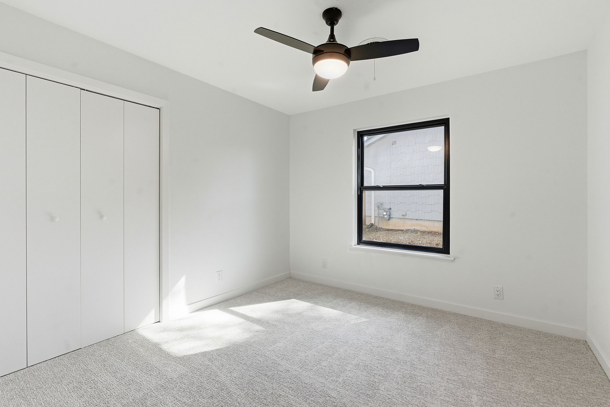 5609 Mapleleaf Drive Austin, TX 78723 - Photo 9 of 19 Unfurnished bedroom with carpet floors, a closet, and a ceiling fan