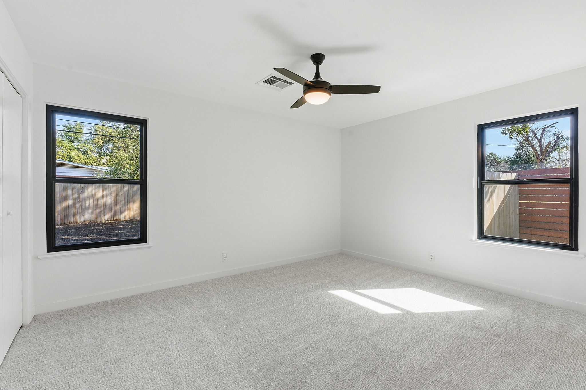 5609 Mapleleaf Drive Austin, TX 78723 - Photo 10 of 19 Unfurnished room featuring light carpet and ceiling fan