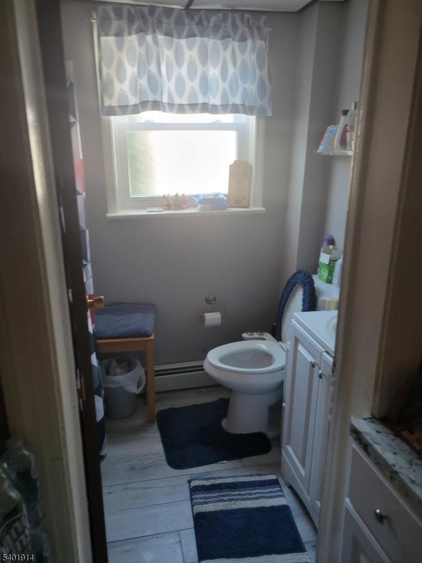 425 Main Street West Orange, NJ 07052 - Photo 15 of 20 a white toilet sitting next to a sink and a window