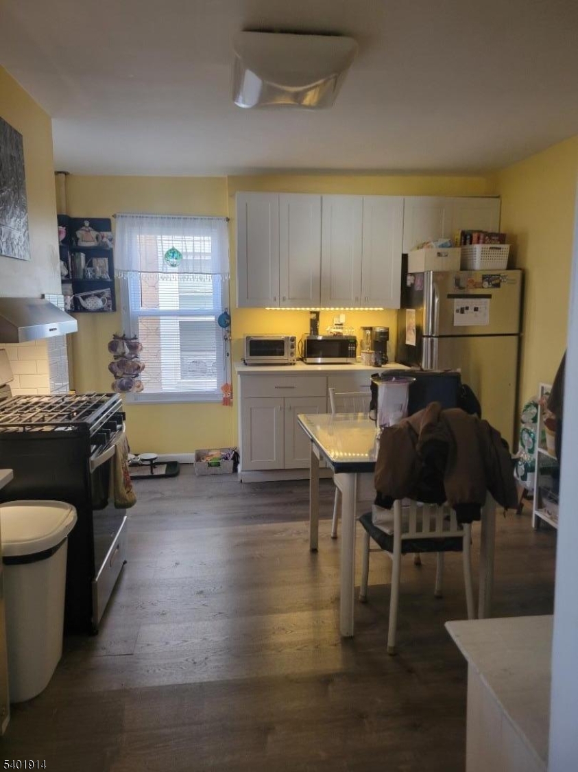 425 Main Street West Orange, NJ 07052 - Photo 4 of 20 a kitchen with a table chairs and a stove