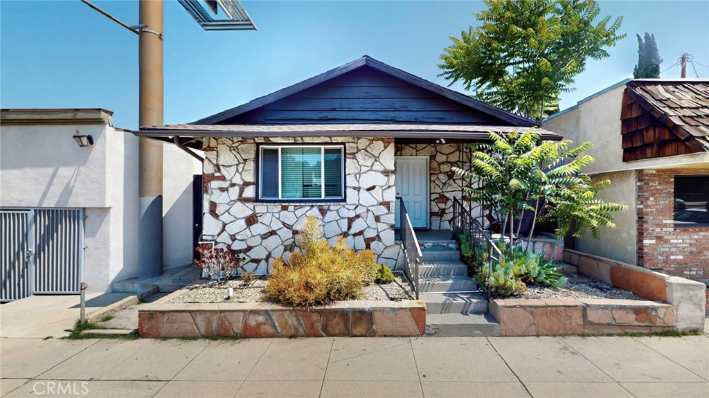 6851 Foothill Boulevard Tujunga, CA 91042 - Photo 9 of 50 a front view of a house with garden