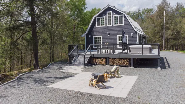 a view of a house with backyard porch and sitting area