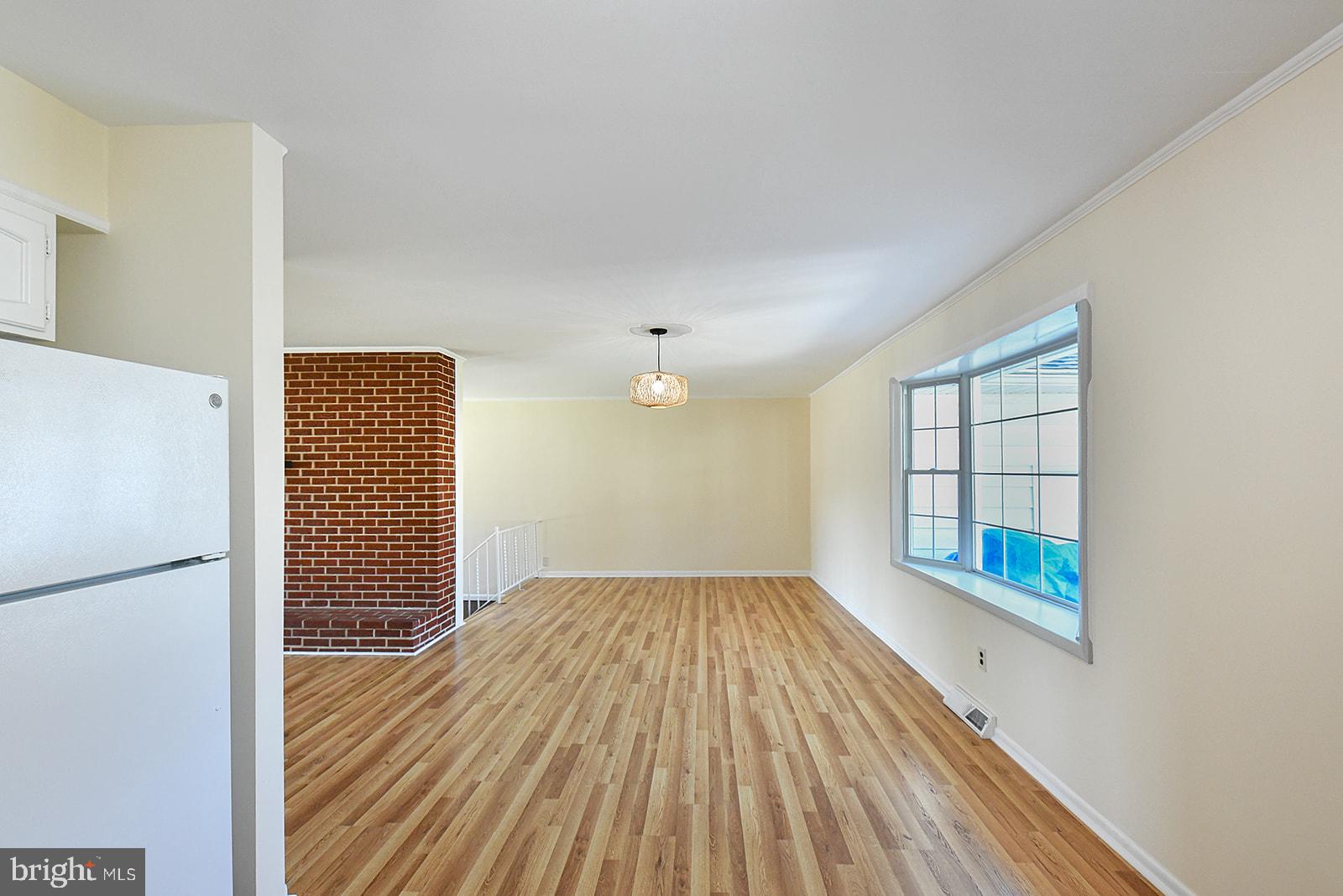 3702 East Joppa Road Nottingham, MD 21236 - Photo 12 of 65 a view of an empty room with wooden floor and a window