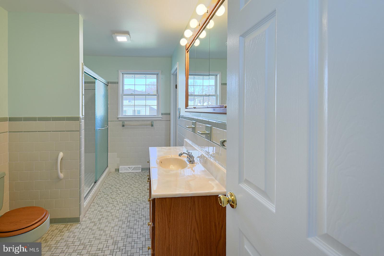 3702 East Joppa Road Nottingham, MD 21236 - Photo 29 of 65 a bathroom with a sink a toilet and shower