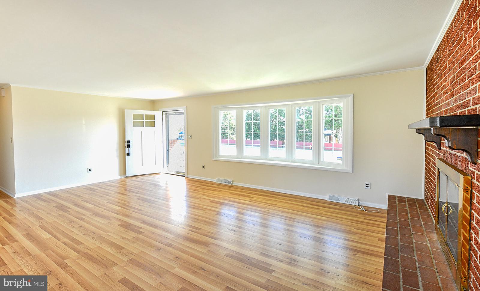 3702 East Joppa Road Nottingham, MD 21236 - Photo 3 of 65 a view of an empty room with wooden floor and a window