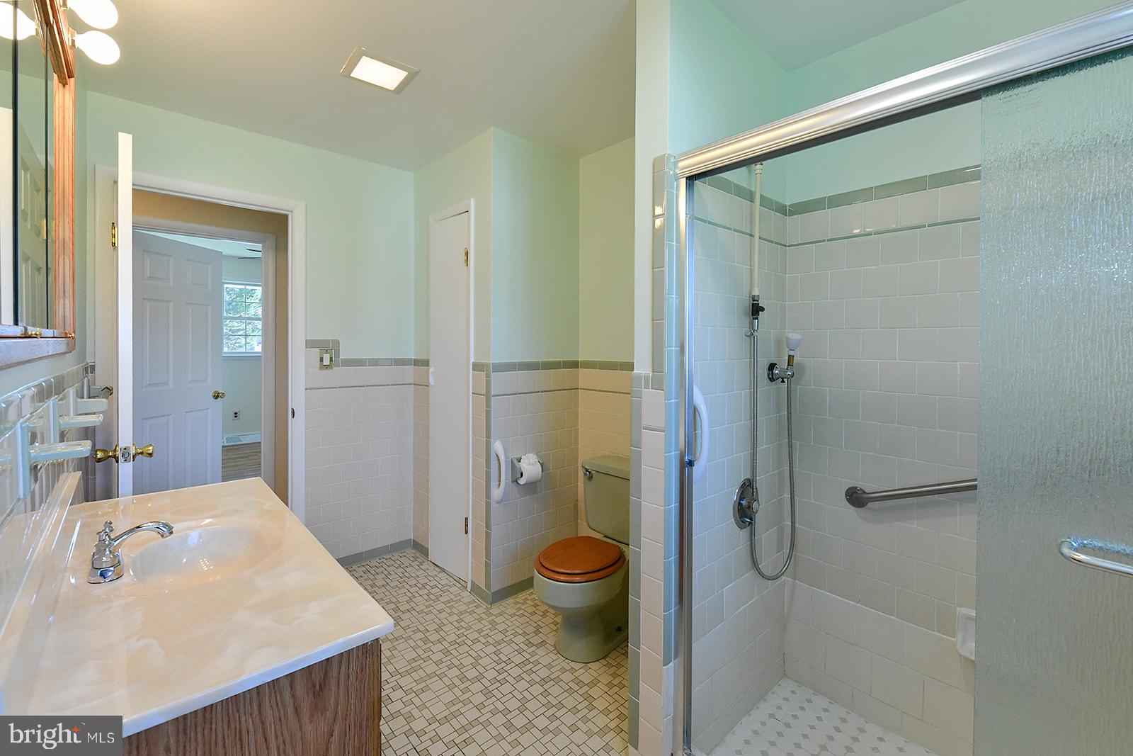 3702 East Joppa Road Nottingham, MD 21236 - Photo 31 of 65 a bathroom with a granite countertop sink a toilet and shower