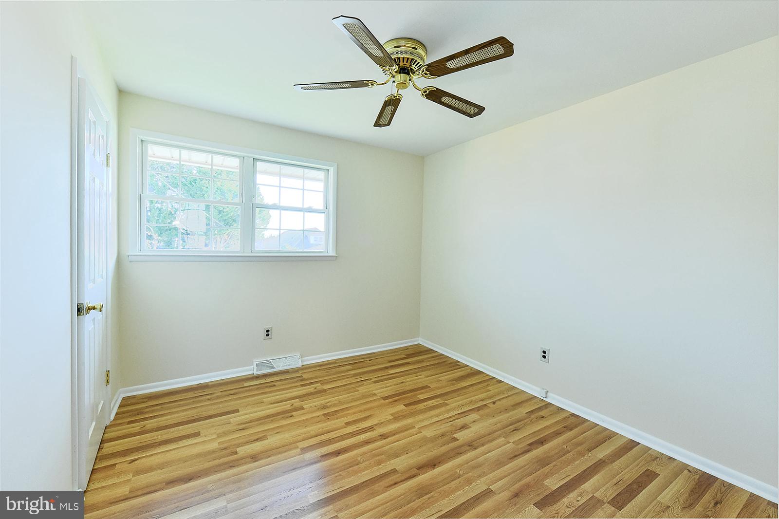 3702 East Joppa Road Nottingham, MD 21236 - Photo 39 of 65 an empty room with a window and a ceiling fan