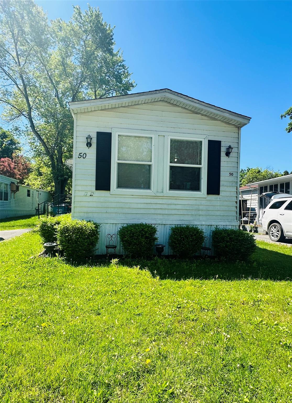 a front view of a house with a garden