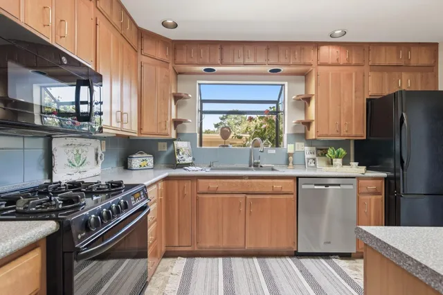 a kitchen with a stove a sink and a refrigerator