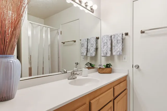 a bathroom with a sink double vanity and a mirror
