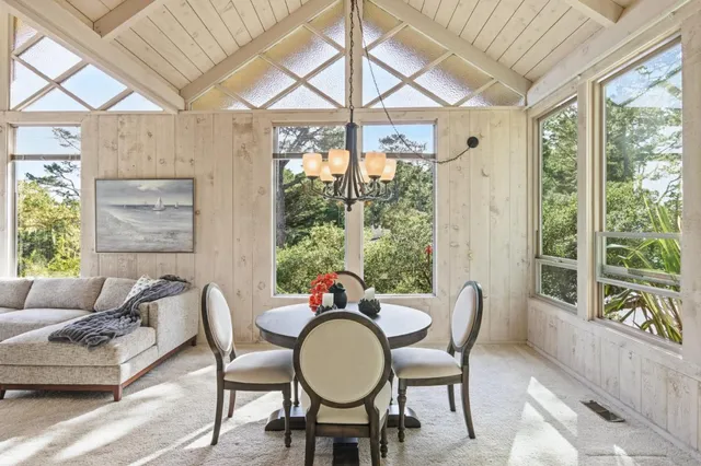 a dining room with furniture window and outside view