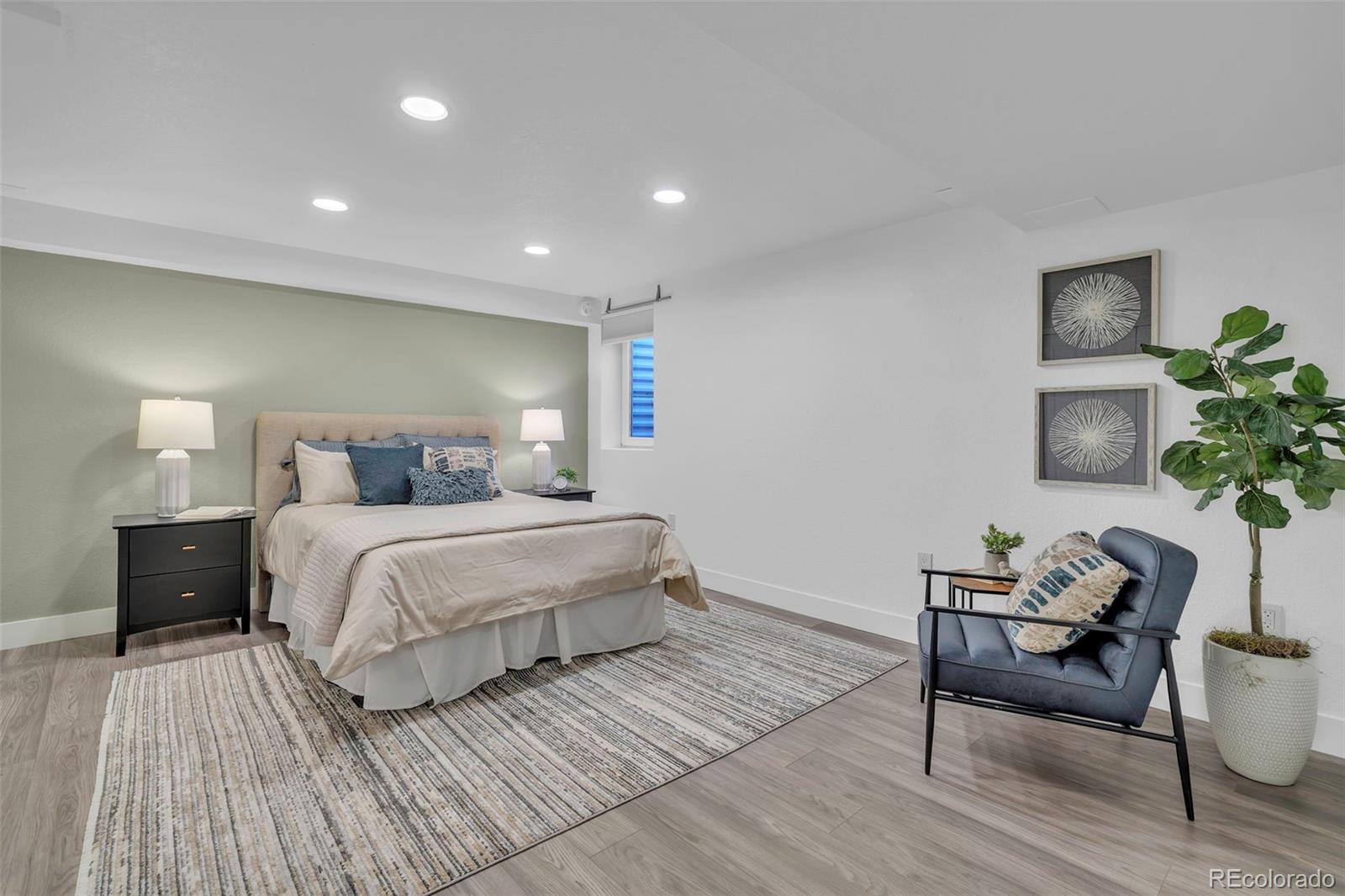 2808 Eaton Street Wheat Ridge, CO 80214 - Photo 13 of 36 a bedroom with a bed and a table