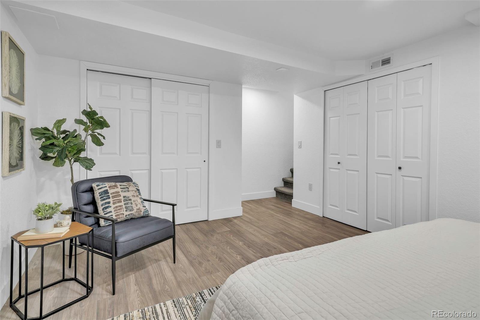 2808 Eaton Street Wheat Ridge, CO 80214 - Photo 14 of 36 a bedroom with a bed and a chair