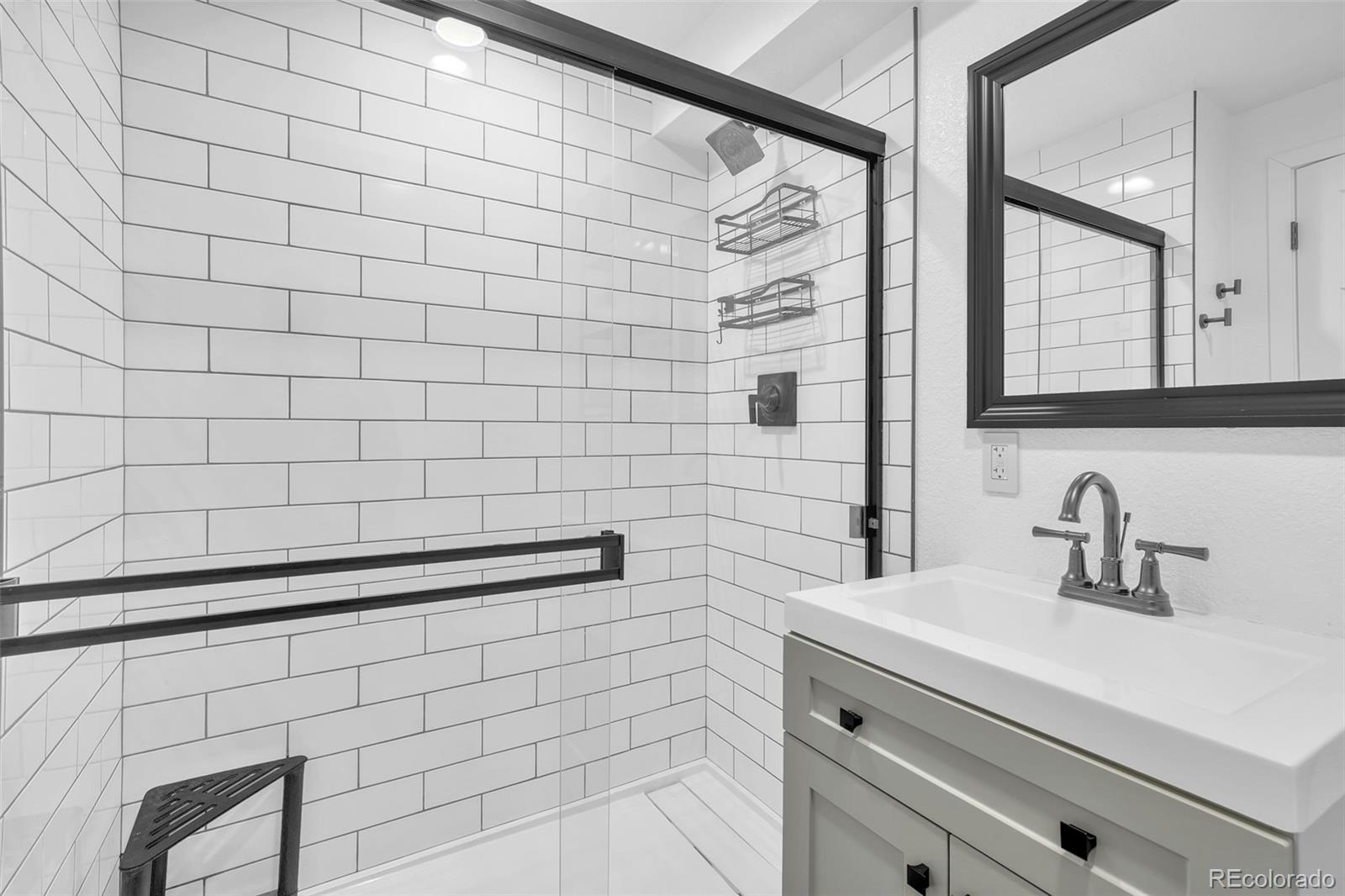 2808 Eaton Street Wheat Ridge, CO 80214 - Photo 15 of 36 a bathroom with a shower