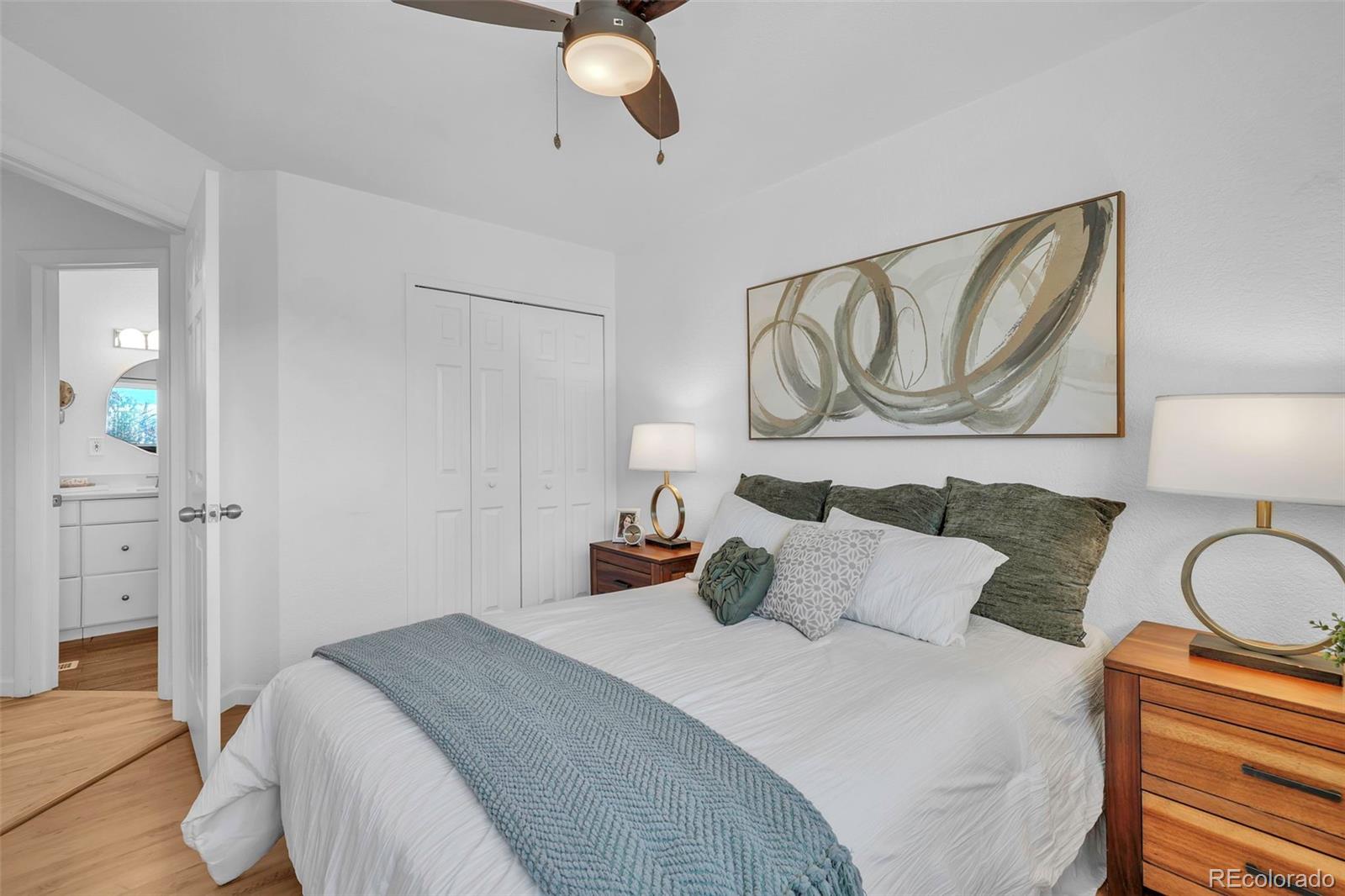 2808 Eaton Street Wheat Ridge, CO 80214 - Photo 20 of 36 a bedroom with a bed and cabinets