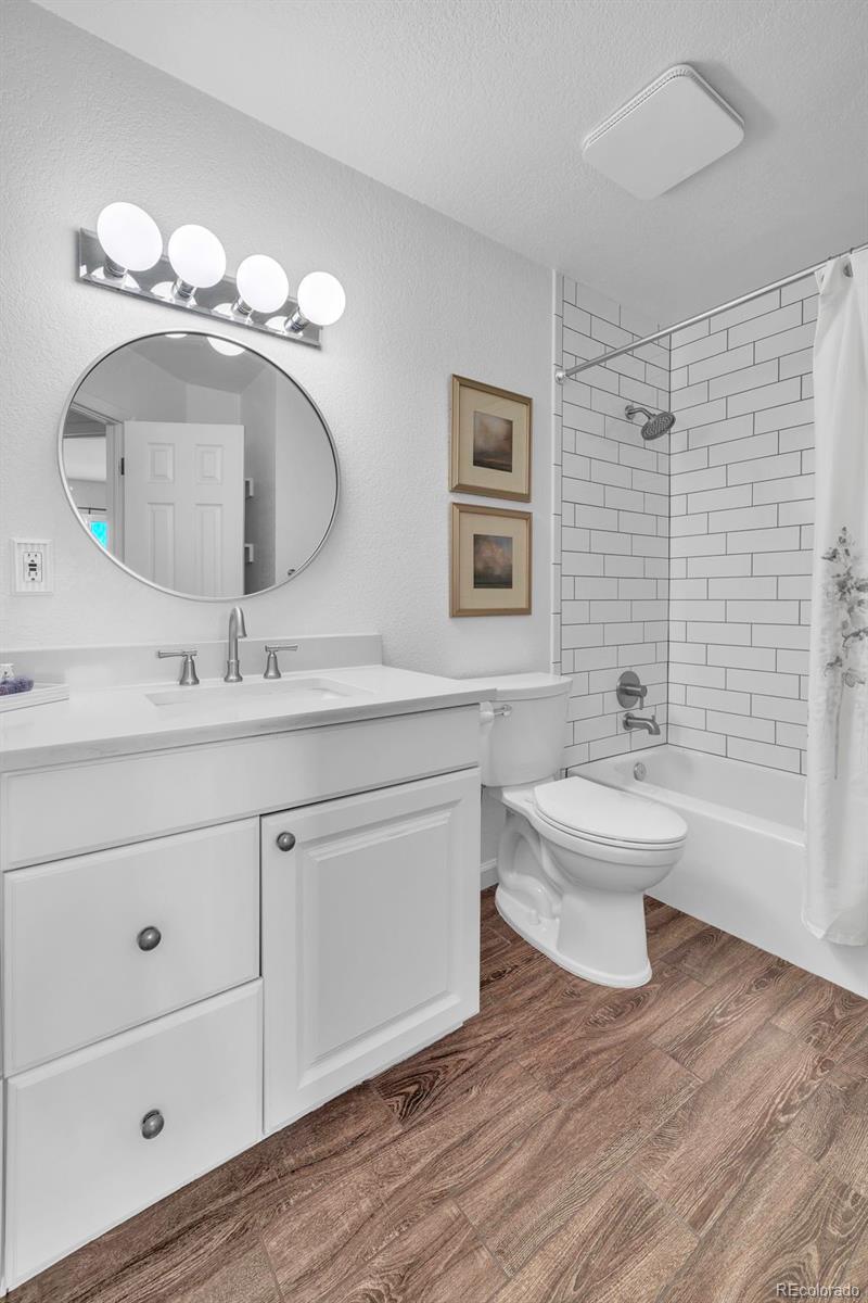 2808 Eaton Street Wheat Ridge, CO 80214 - Photo 22 of 36 a bathroom with a toilet sink and mirror