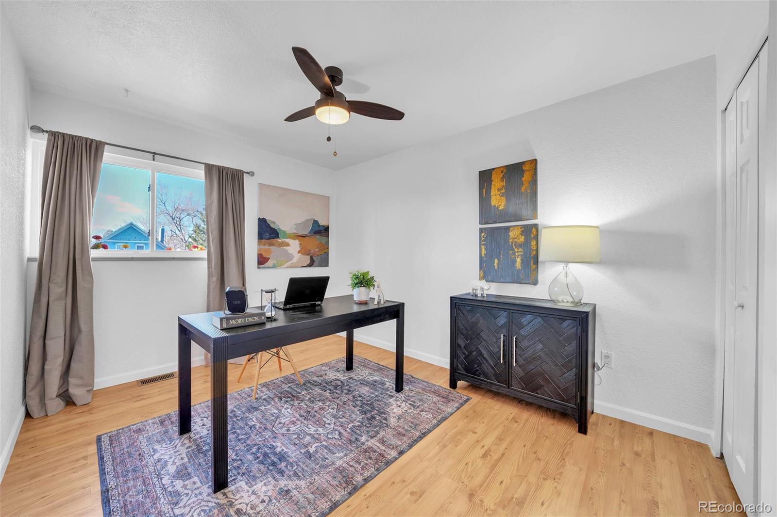 2808 Eaton Street Wheat Ridge, CO 80214 - Photo 23 of 36 a view of a workspace with furniture and a window