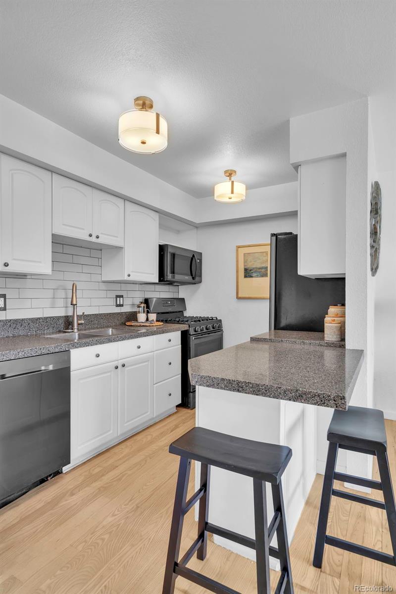 2808 Eaton Street Wheat Ridge, CO 80214 - Photo 4 of 36 a kitchen with stainless steel appliances granite countertop a stove a sink dishwasher and a refrigerator