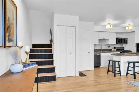 a view of kitchen with sink and refrigerator