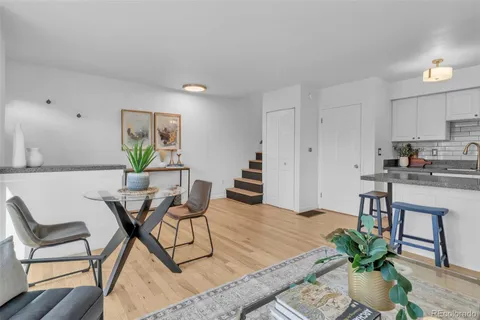 a living room with furniture and a dining table