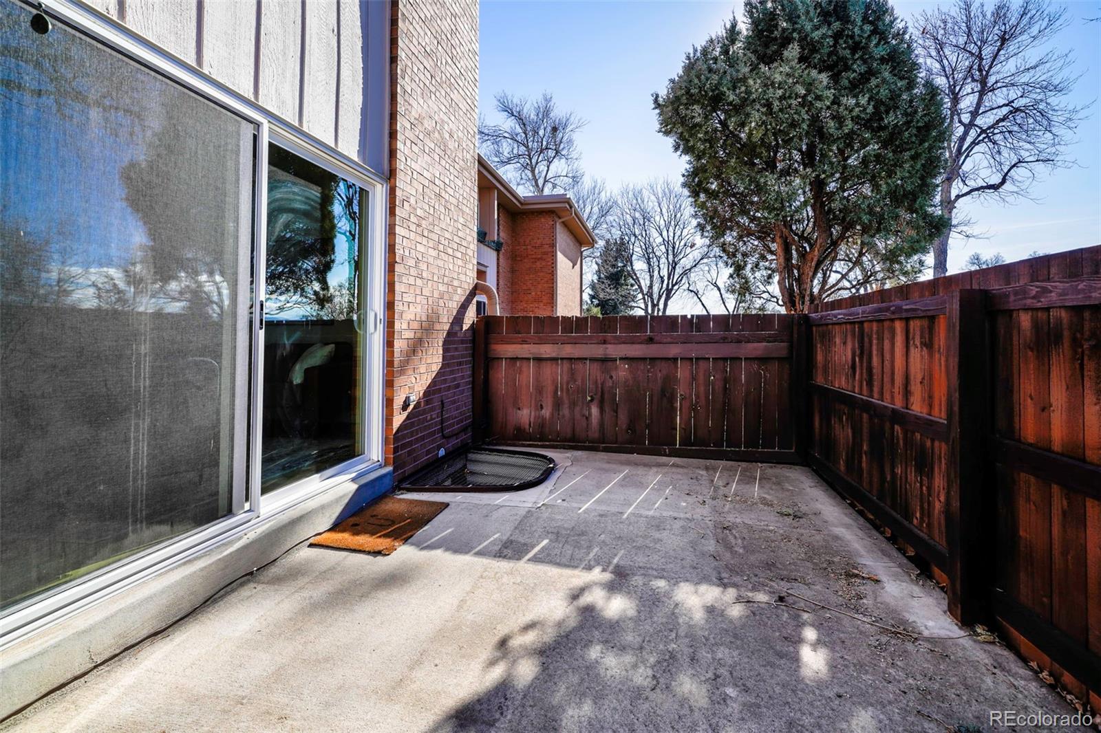2808 Eaton Street Wheat Ridge, CO 80214 - Photo 10 of 36 a view of backyard with wooden fence and large trees
