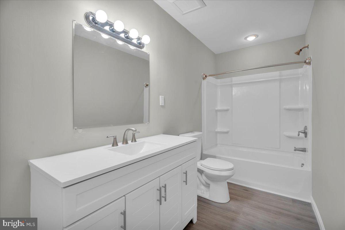 301 County House Road Sewell, NJ 08080 - Photo 11 of 23 a bathroom with a sink a toilet a mirror and shower