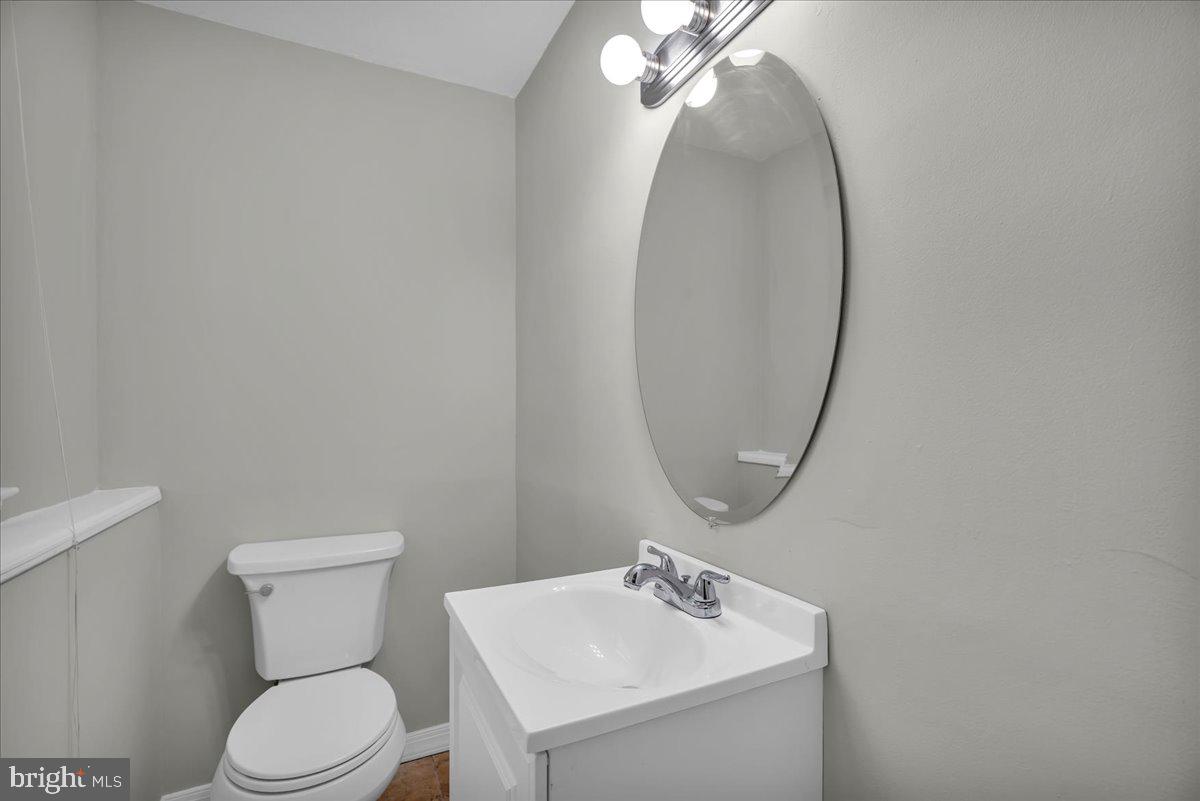 301 County House Road Sewell, NJ 08080 - Photo 16 of 23 a bathroom with a toilet a sink and mirror