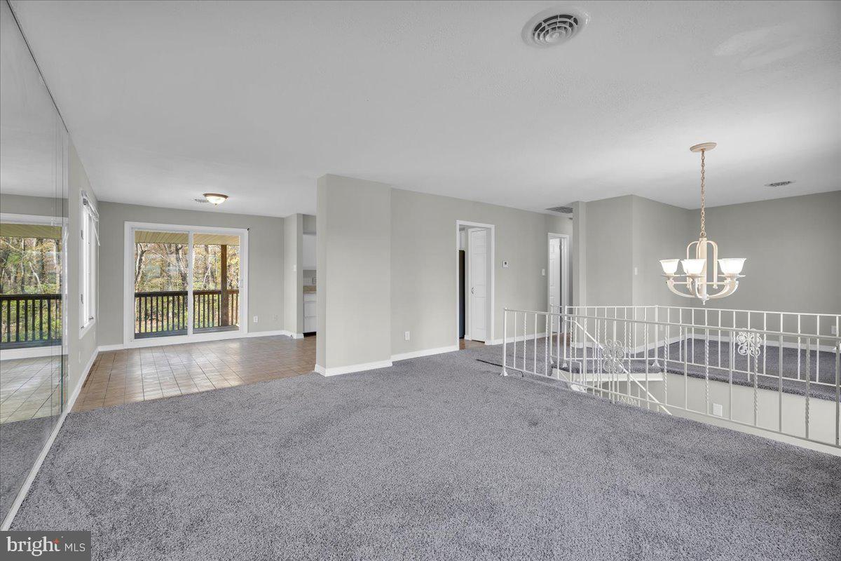 301 County House Road Sewell, NJ 08080 - Photo 5 of 23 an empty room with chandelier fan and windows