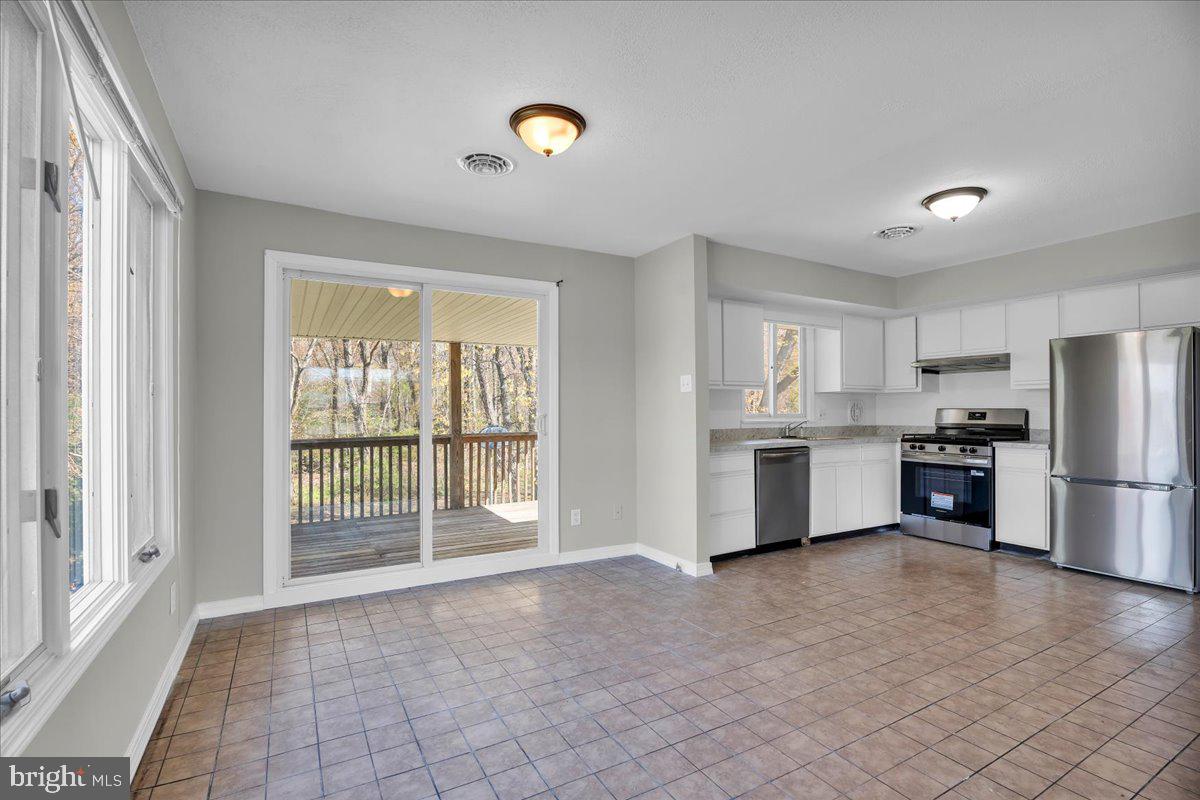 301 County House Road Sewell, NJ 08080 - Photo 7 of 23 a view of a kitchen with refrigerator and microwave